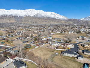 Aerial overview of property's location with a mountain backdrop and nearby suburban area