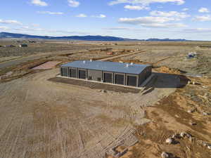 Aerial view of sparsely populated area with a mountain backdrop and a desert landscape