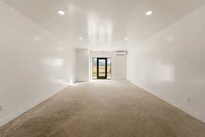 Unfurnished room featuring concrete floors and a mini split for heating / cooling