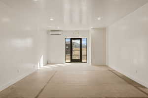 Empty room featuring concrete floors and recessed lighting