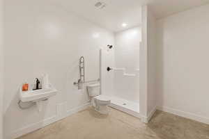 Full bathroom featuring concrete floors, a shower stall, and recessed lighting