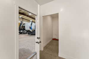 Hall featuring concrete floors and baseboards