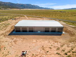 Entry to storm shelter featuring a view of rural / pastoral area, a mountain view, and an outdoor structure