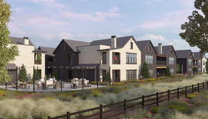 Back of property with stone siding, a residential view, a patio, and an outdoor living space