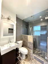 Bathroom featuring vanity and a stall shower