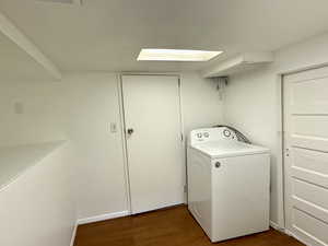 Laundry room featuring washer / clothes dryer and dark wood-style floors