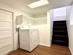 Laundry area featuring washer / dryer and wood finished floors