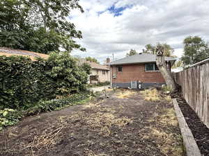 Rear view of property with brick siding and a chimney