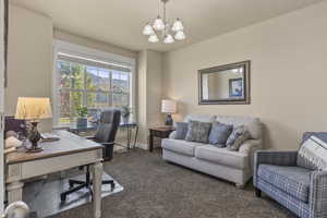 Office space featuring carpet and a chandelier