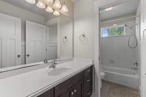 Bathroom with  shower combination, vanity, and light tile patterned floors