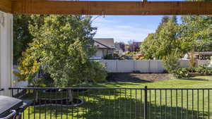 Fenced backyard with a fenced deck.