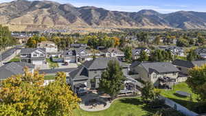 Aerial view of property and surrounding area featuring a mountainous background