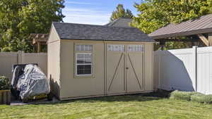 View of shed with a fenced backyard