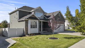 View of front of property featuring stone siding, concrete driveway, a shingled roof, and an attached garage
