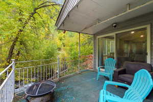 View of patio with a fire pit