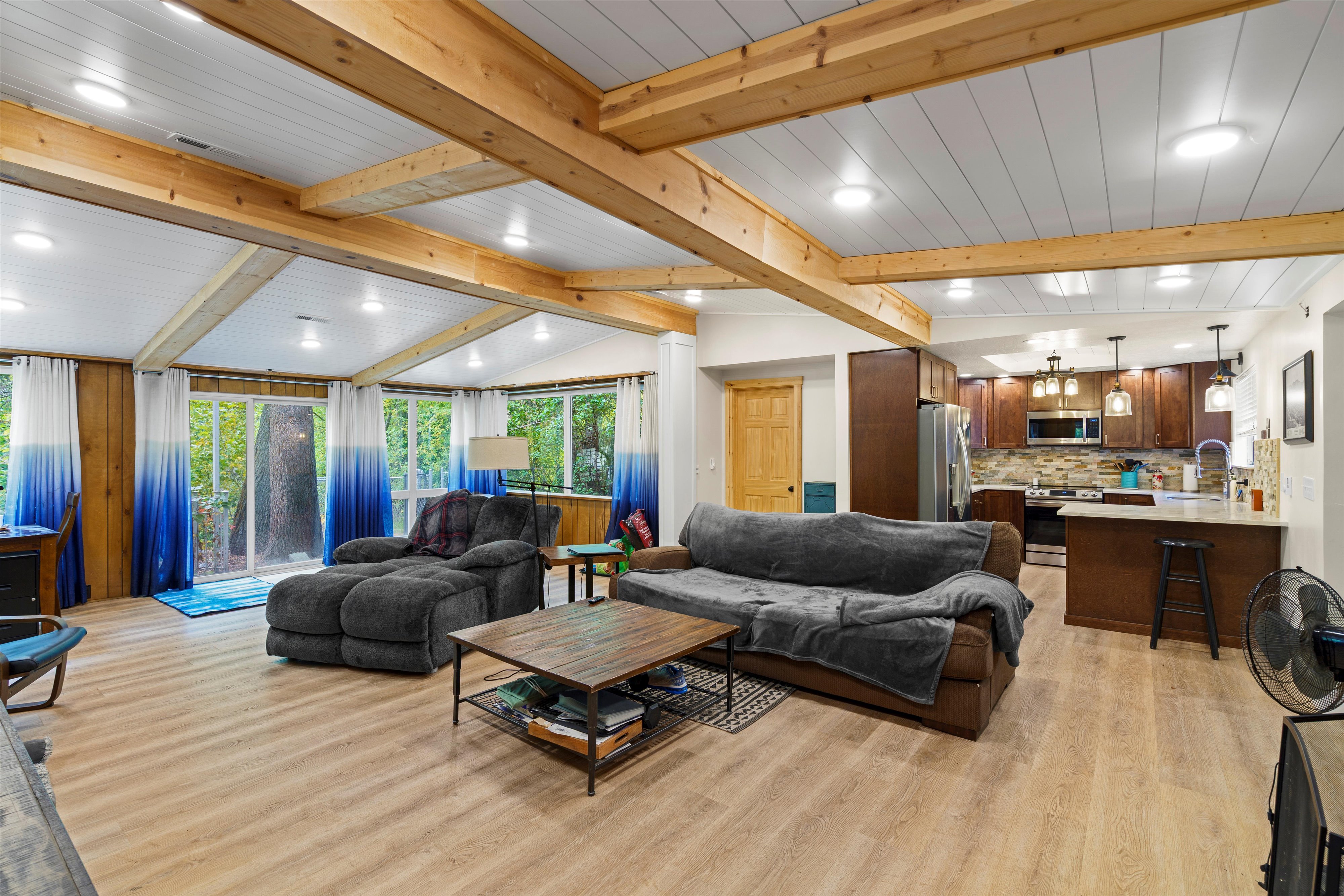 Living room with plenty of natural light, light wood-type flooring, and recessed lighting