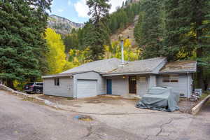 Garage with a mountain view and asphalt driveway