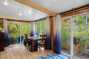 Sunroom featuring wood finished floors, healthy amount of natural light, recessed lighting, and wooden ceiling