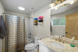 Bathroom with shower / bath combo and vanity