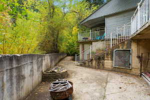 Patio / terrace with stairs, a forest view, and a patio area