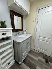 Bathroom with vanity and wood-type flooring
