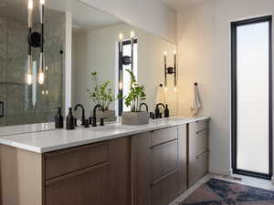 Bathroom featuring double vanity and a shower stall