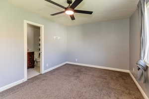 Spare room with carpet flooring, a ceiling fan, and a textured ceiling