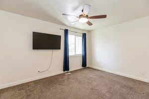 Spare room with carpet floors and ceiling fan