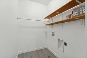 Laundry room with washer hookup, hookup for an electric dryer, and wood finish floors