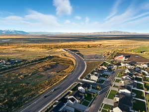 Aerial overview of property's location featuring nearby suburban area and a mountainous background