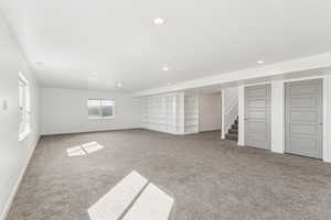 You will spend hours enjoying this spacious family room. Basement with light carpet, stairs, and recessed lighting