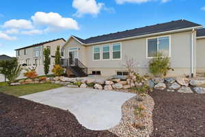 Back of house with a patio area, stucco siding, and a yard