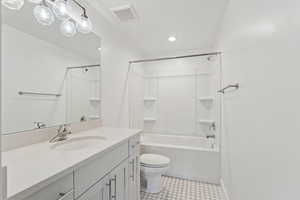 Full bathroom featuring tub / shower combination, vanity, recessed lighting, and light tile patterned floors