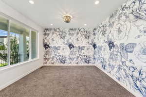 Carpeted spare room with recessed lighting and wallpapered walls