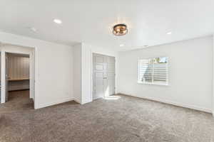 Unfurnished bedroom featuring carpet flooring, recessed lighting, and a closet