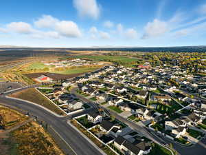 Aerial view of property and surrounding area featuring nearby suburban area and mountains
