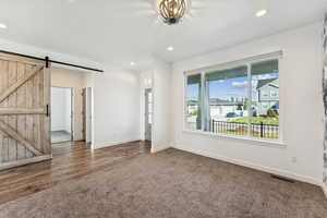 Unfurnished room with dark colored carpet,, and recessed lighting