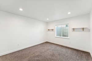 Unfurnished room featuring dark carpet and recessed lighting