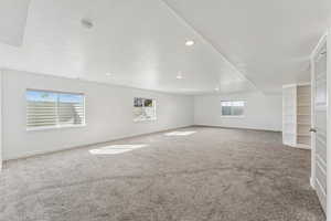 Unfurnished room featuring light colored carpet, a textured ceiling, and recessed lighting