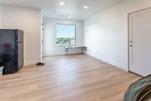 Unfurnished living room featuring recessed lighting and light wood-type flooring
