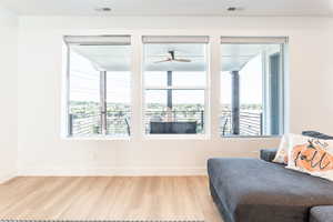 Bedroom featuring multiple windows and wood finished floors