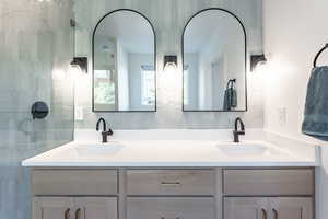 Bathroom with backsplash and double vanity