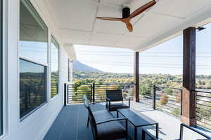 Balcony featuring ceiling fan and a mountain view