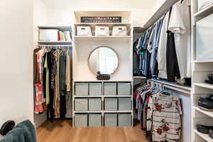 Walk in closet featuring light wood finished floors