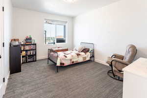 Carpeted bedroom with baseboards