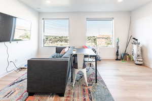 Living area featuring light wood-style floors and recessed lighting