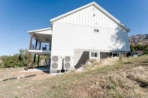 View of side of property featuring a ceiling fan, a patio, and board and batten siding