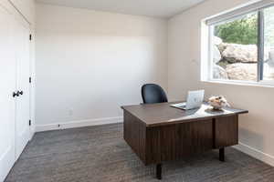 Office space featuring dark colored carpet