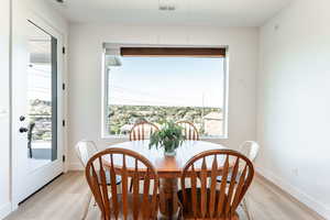 Dining room featuring light wood-style floors and baseboards