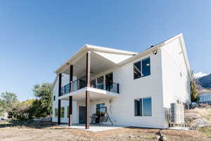 Rear view of house featuring a patio and ceiling fan